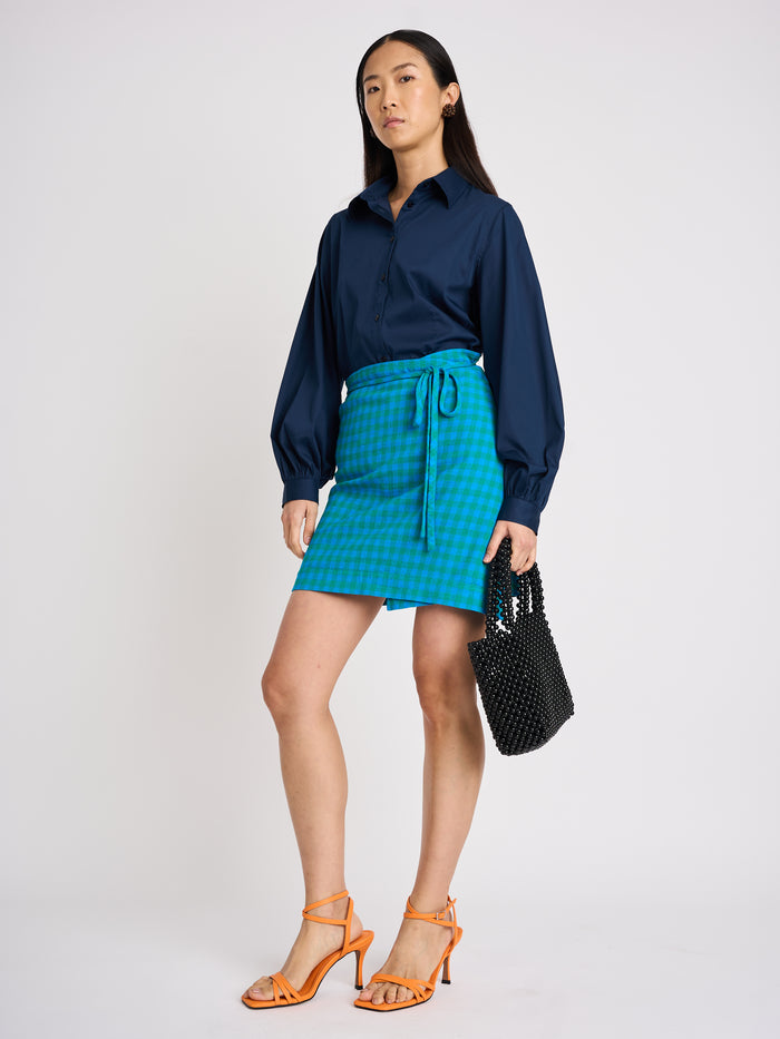 The Lucie Marquis 'Edie Mini Sarong', a versatile wrap skirt inspired by the iconic style of Edie Sedgwick from the swinging 60s. This mini sarong transitions effortlessly from day to night, making it ideal for all travel adventures - perfect for sun-kissed days at the beach or city evenings. Pair it with a tank top or t-shirt for a casual look, or dress it up with heels for a party-ready look.