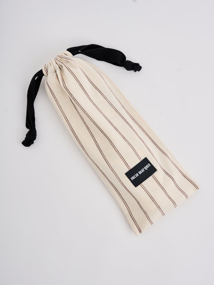 The Lucie Marquis 'Edie Mini Sarong', a versatile wrap skirt inspired by the iconic style of Edie Sedgwick from the swinging 60s. This mini sarong transitions effortlessly from day to night, making it ideal for all travel adventures - perfect for sun-kissed days at the beach or city evenings. Pair it with a tank top or t-shirt for a casual look, or dress it up with heels for a party-ready look.