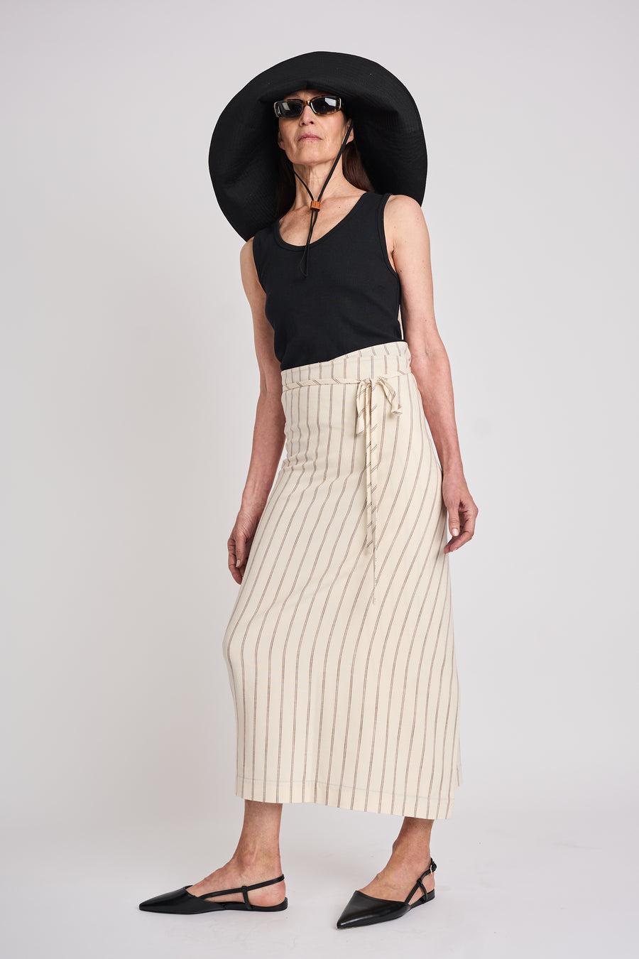 The Lucie Marquis ‘Rae Midi’, a timeless midi-length wrap skirt. An essential holiday item - this versatile piece, effortlessly transitions from day to night, making it ideal for all travel adventures. Whether lounging by the pool or exploring city life, the Rae Midi adds elegance to any ensemble.