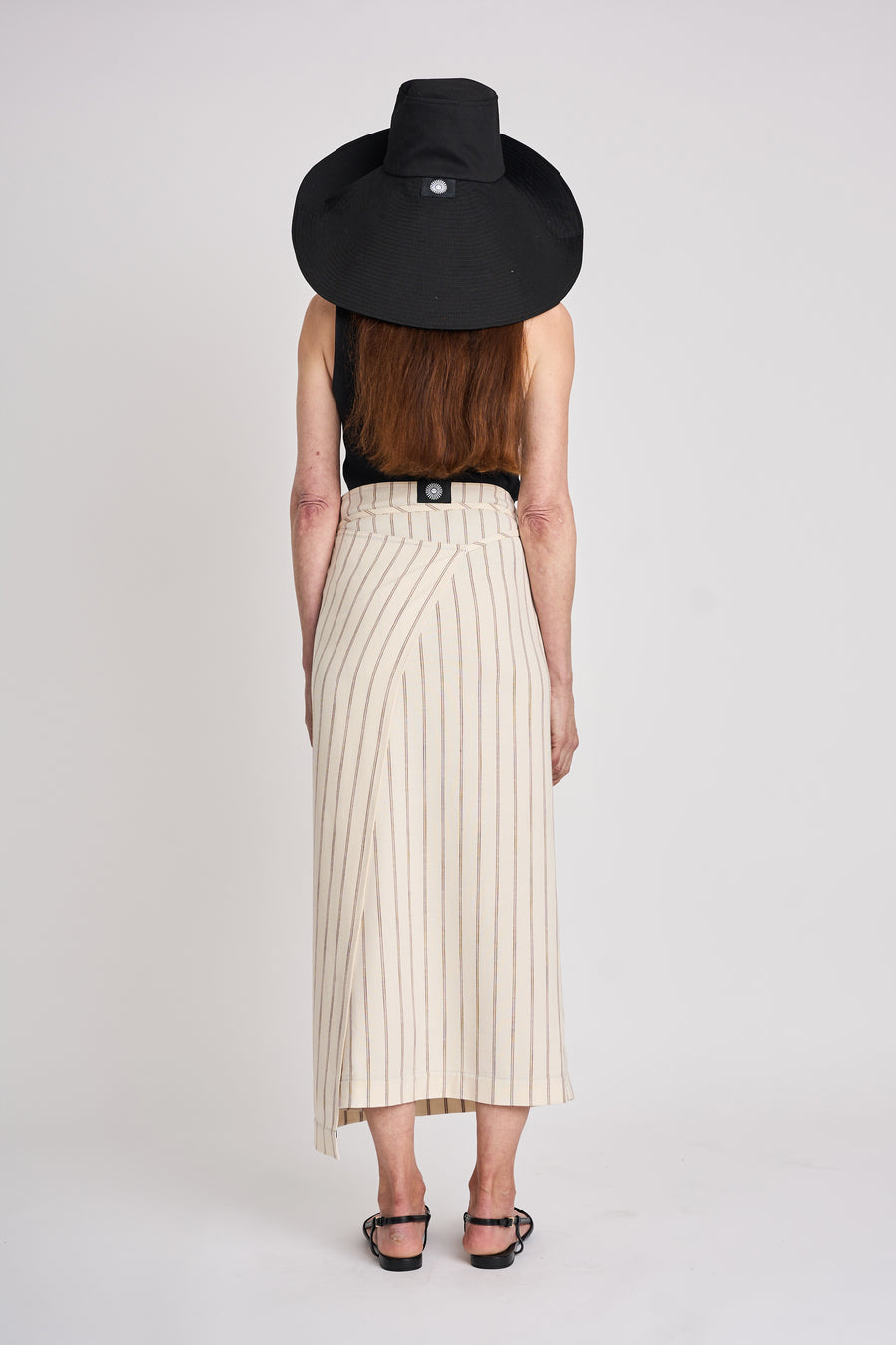 The Lucie Marquis 'Dylan Sunhat' is a wide brimmed sun hat made from high quality cotton twill with heavy topstitching and a wooden block cord end. Inspired by the iconic spirit of Bob Dylan and the bold essence of Georgia O'Keeffe, the sun hat embodies timeless style with a subtle nod to the 70s and a touch of cowboy charm. Perfect for shielding from the sun, it's the ideal accessory for your travel adventures.