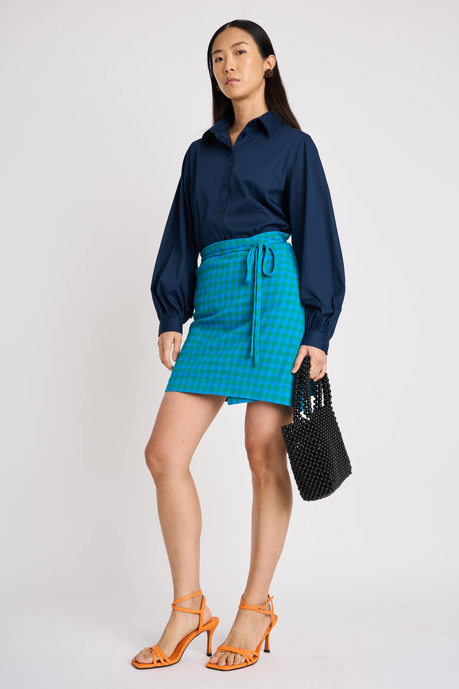 The Lucie Marquis 'Edie Mini Sarong', a versatile wrap skirt inspired by the iconic style of Edie Sedgwick from the swinging 60s. This mini sarong transitions effortlessly from day to night, making it ideal for all travel adventures - perfect for sun-kissed days at the beach or city evenings. Pair it with a tank top or t-shirt for a casual look, or dress it up with heels for a party-ready look.