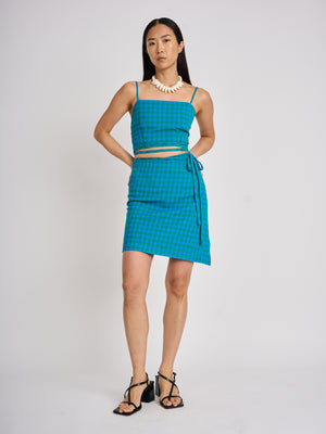 The Lucie Marquis 'Edie Mini Sarong', a versatile wrap skirt inspired by the iconic style of Edie Sedgwick from the swinging 60s. This mini sarong transitions effortlessly from day to night, making it ideal for all travel adventures - perfect for sun-kissed days at the beach or city evenings. Pair it with a tank top or t-shirt for a casual look, or dress it up with heels for a party-ready look.